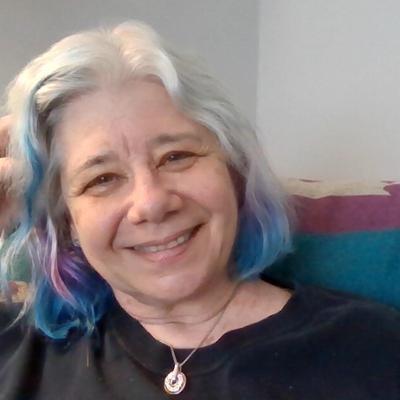 Woman with gray and blue hair smiling
